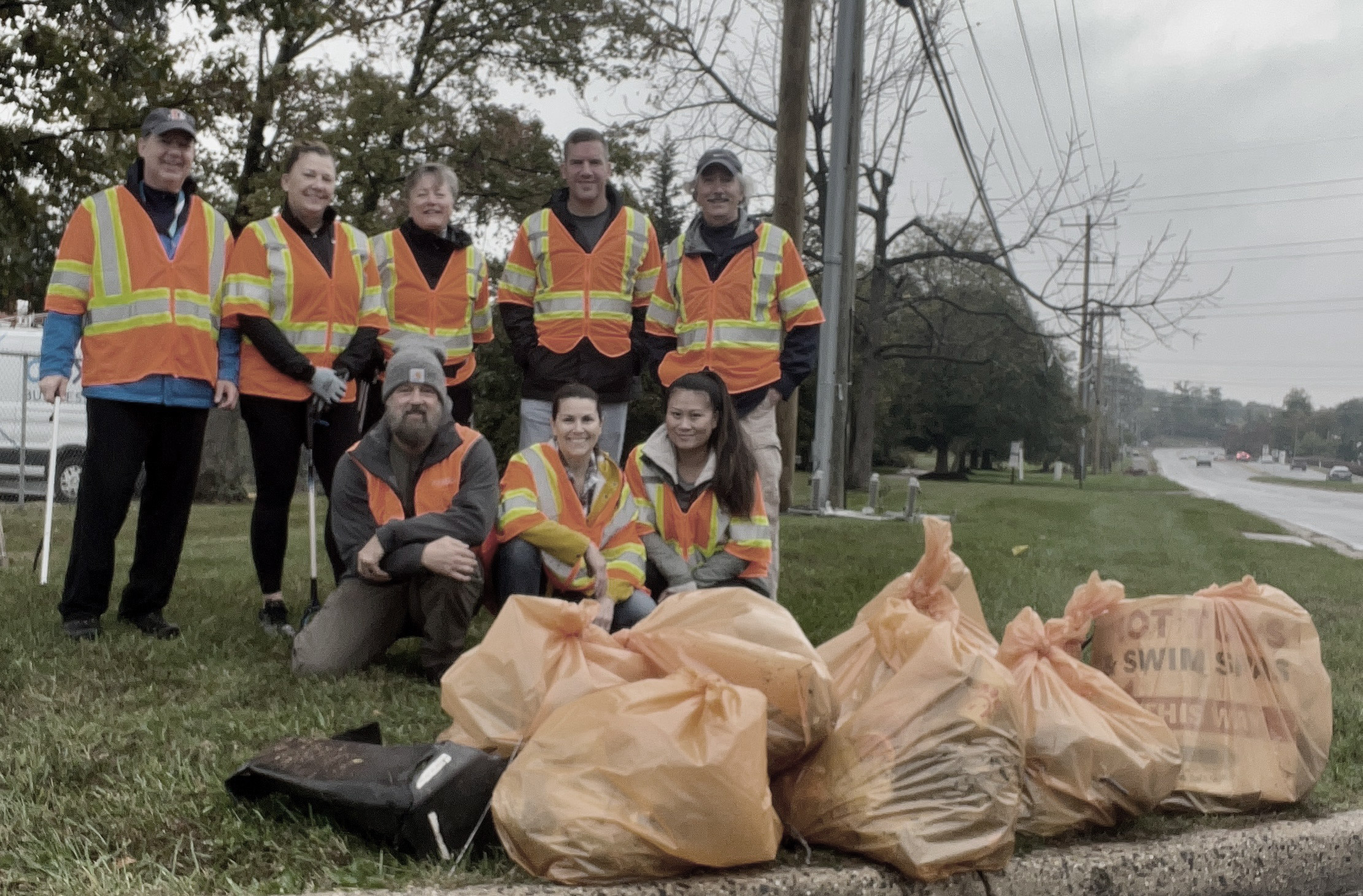 A group of SPA employees pose after cleaning up the highway together in the community