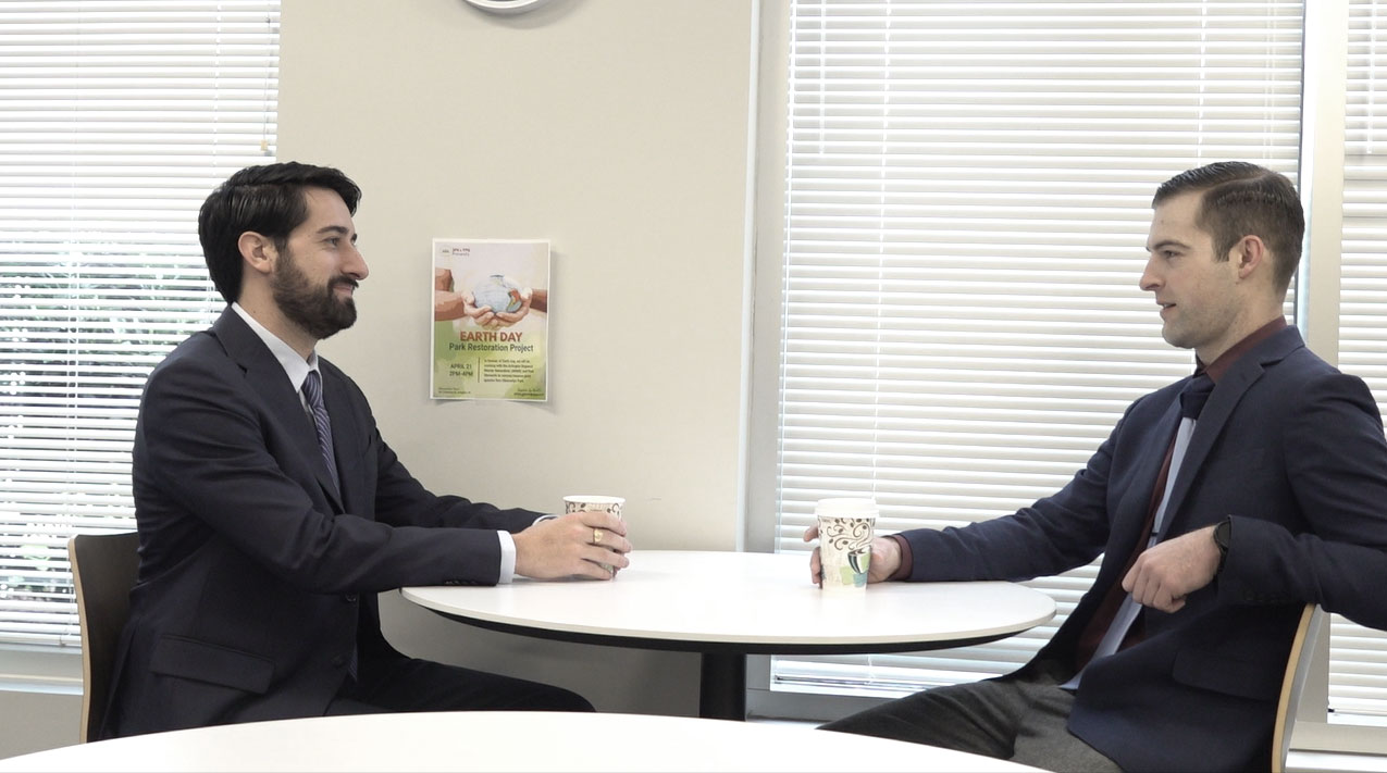 Two SPA employees in discussion over coffee in the SPA breakroom