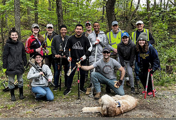 A group of SPA employees clean up invasive plant species from Glencarlyn Park in Arlington, VA