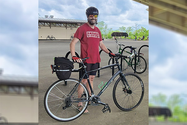 An SPA employee poses after biking to the office to inspire others to be more green