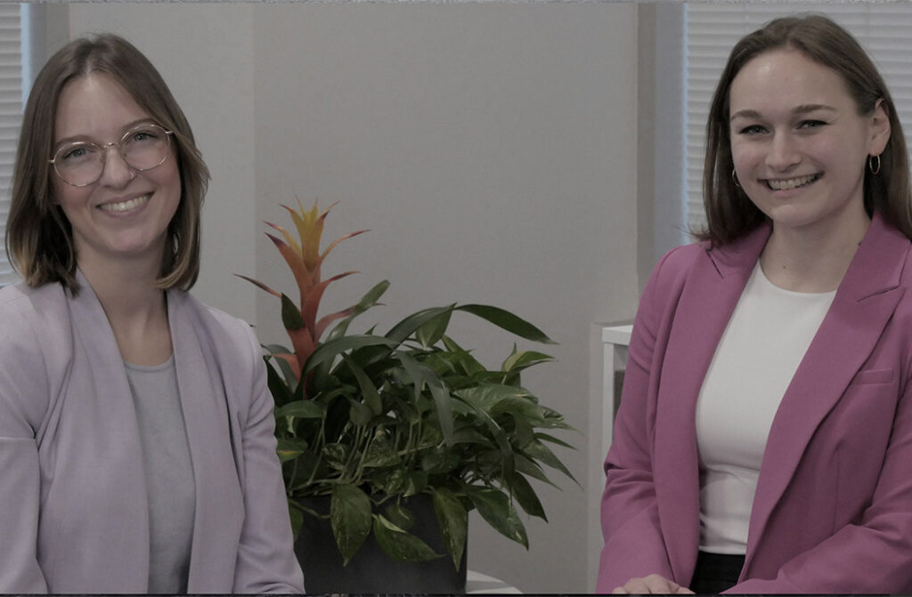 Two SPA employees smile while they are bieing interviewed about their contributions to SPA's Employee Resource Group, WINK, or Women’s Initiative for Networking and Knowledge