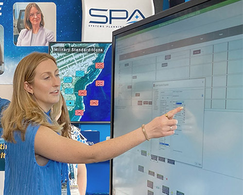 An SPA employee demonstrates SPA's Athena, a user-friendly digital play surface for mission-planning table top exercises and wargaming