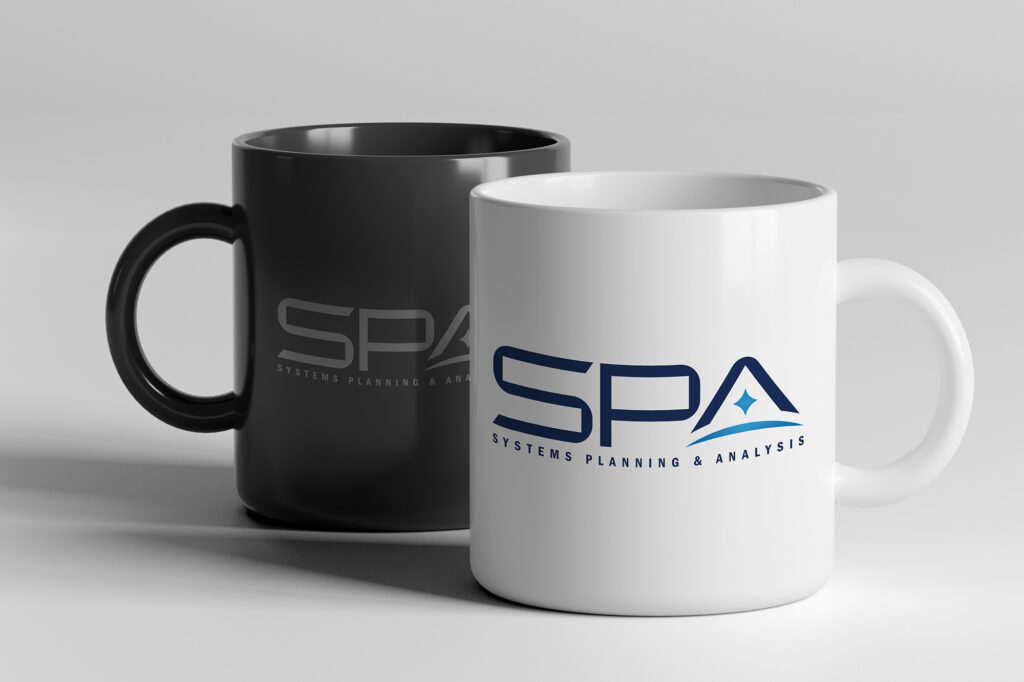 A pair of SPA-branded coffee mugs in black and white