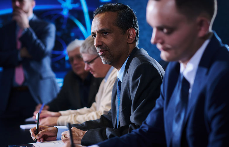 SPA employees listen to each other during a meeting in a conference room at SPA headquarters in Alexandria