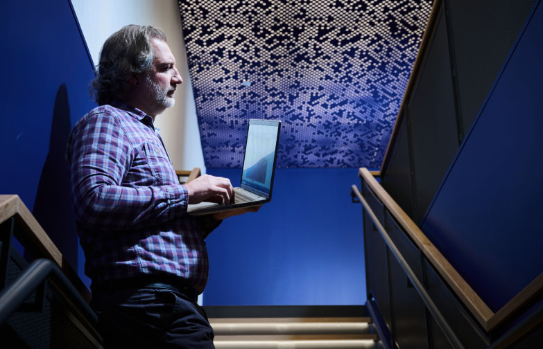 An SPA employee works on his laptop in the hall at SPA headquarters in Alexandria