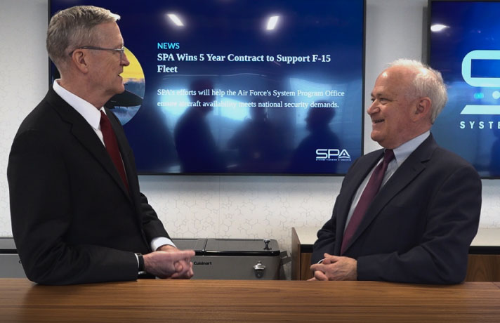 Two SPA Fellows laugh together in the Horizon Lounge at SPA headquarters in Alexandria