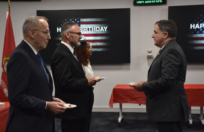 SPA VETs Employee Resource Group serve cake to celebrate the Marine Corps birthday