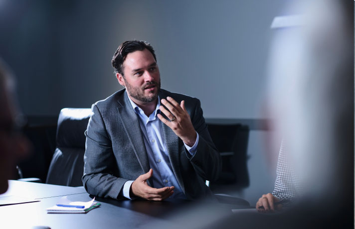 An SPA employee gestures with his hand as he speaks during a meeting at SPA headquarters in Alexandria