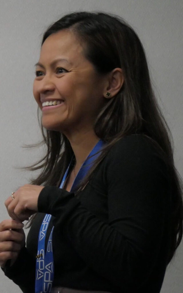 An SPA employee smiles as she leads a meeting at SPA headquarters in Alexandria