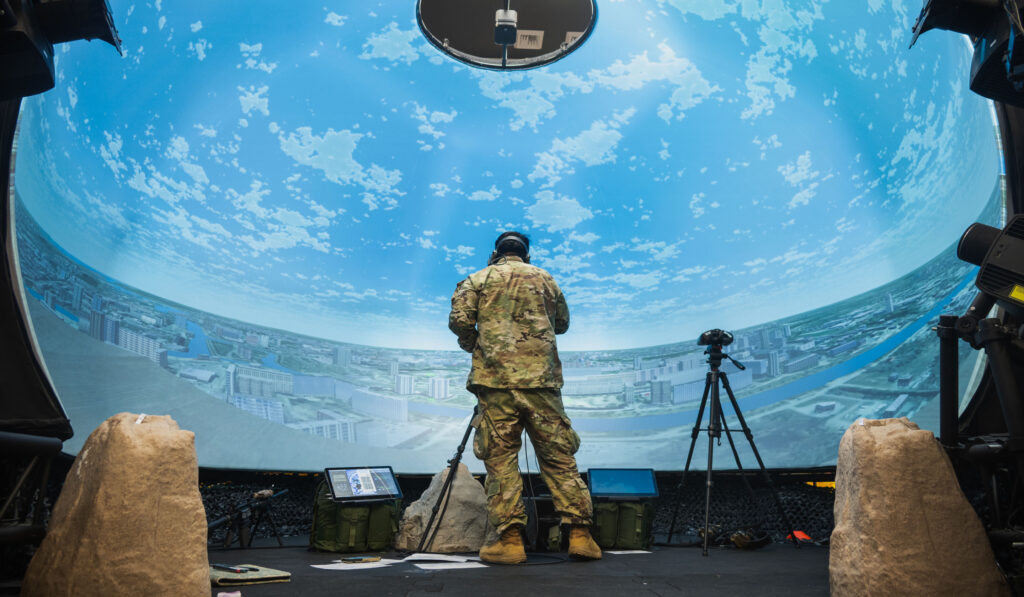 A stock image of a military member standing with VR headset depicting modeling and simulation