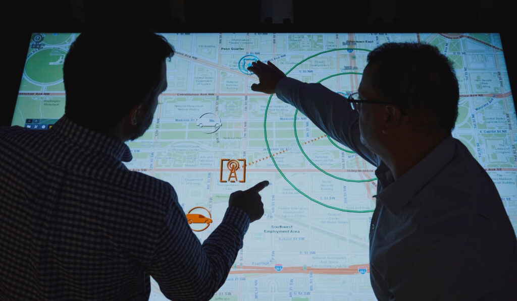 A silhouette of two SPA employees wargaming on AthenaSight technology