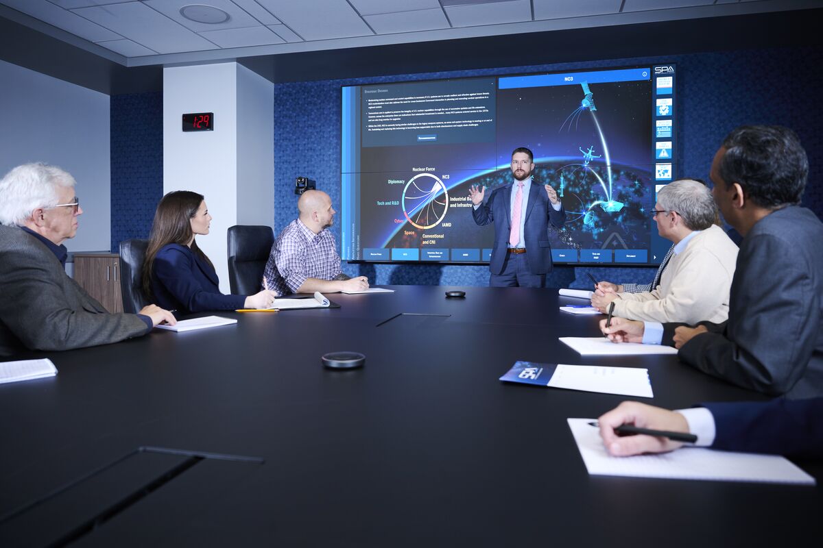 SPA employees meet around a conference table in the HQ building in Alexandria, VA