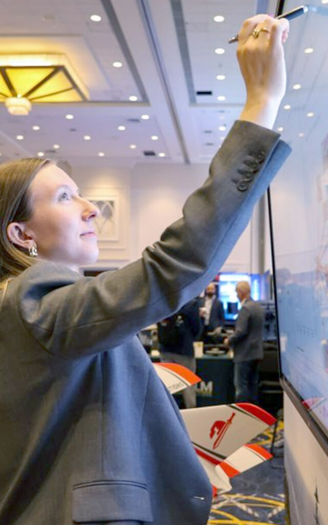 An SPA employee writes on a whiteboard at one of the latest conferences