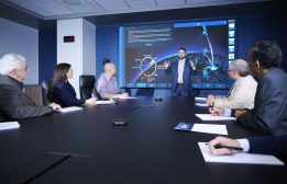 SPA employees meet around a conference table in the HQ building in Alexandria, VA